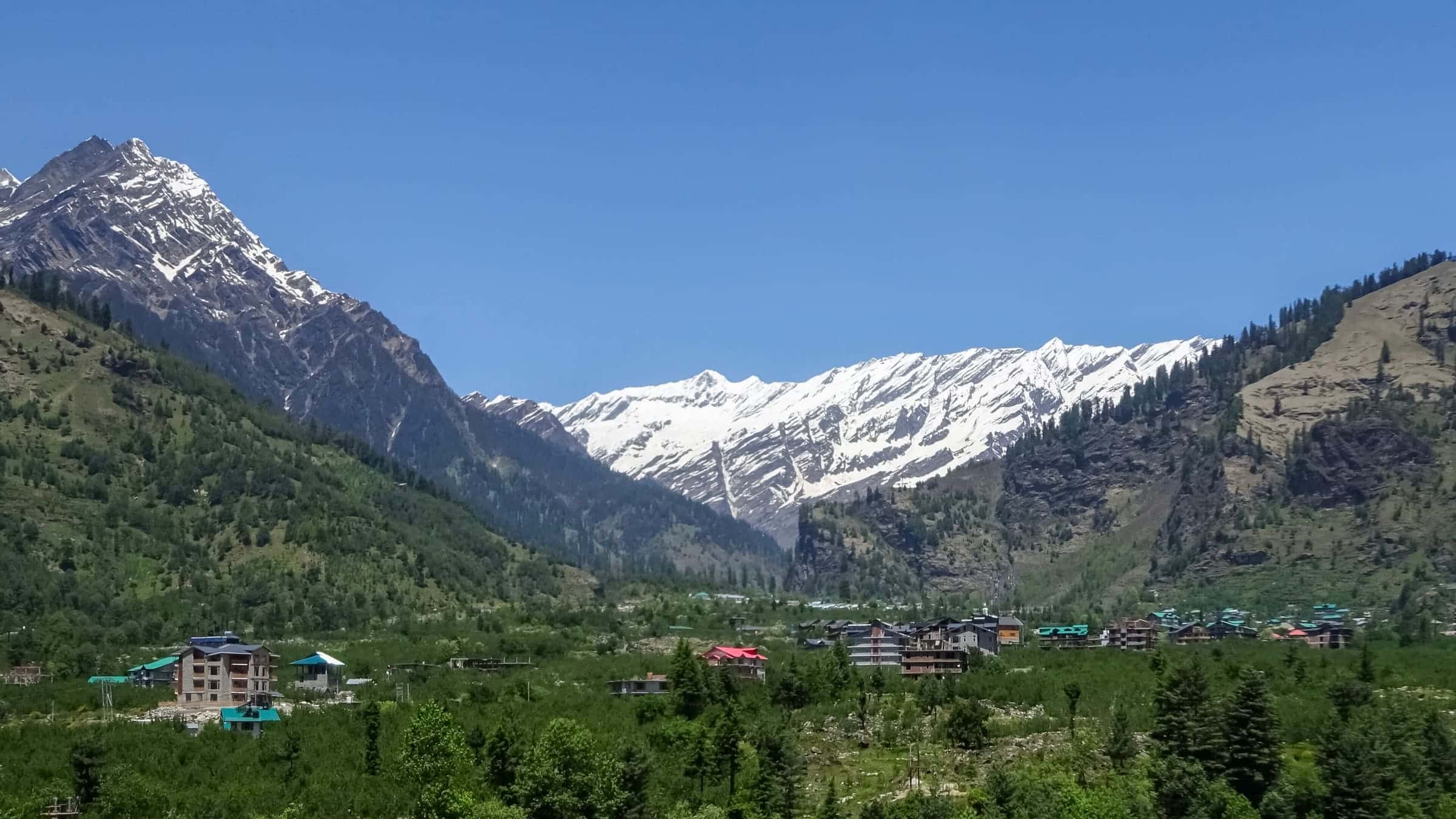 Snow peaks above the green Kullu valley near Manali