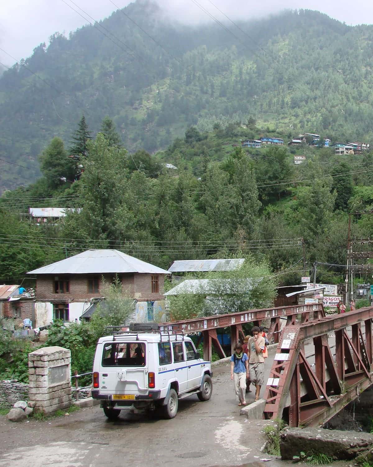 Wooden bridge and guesthouses in Old Manali