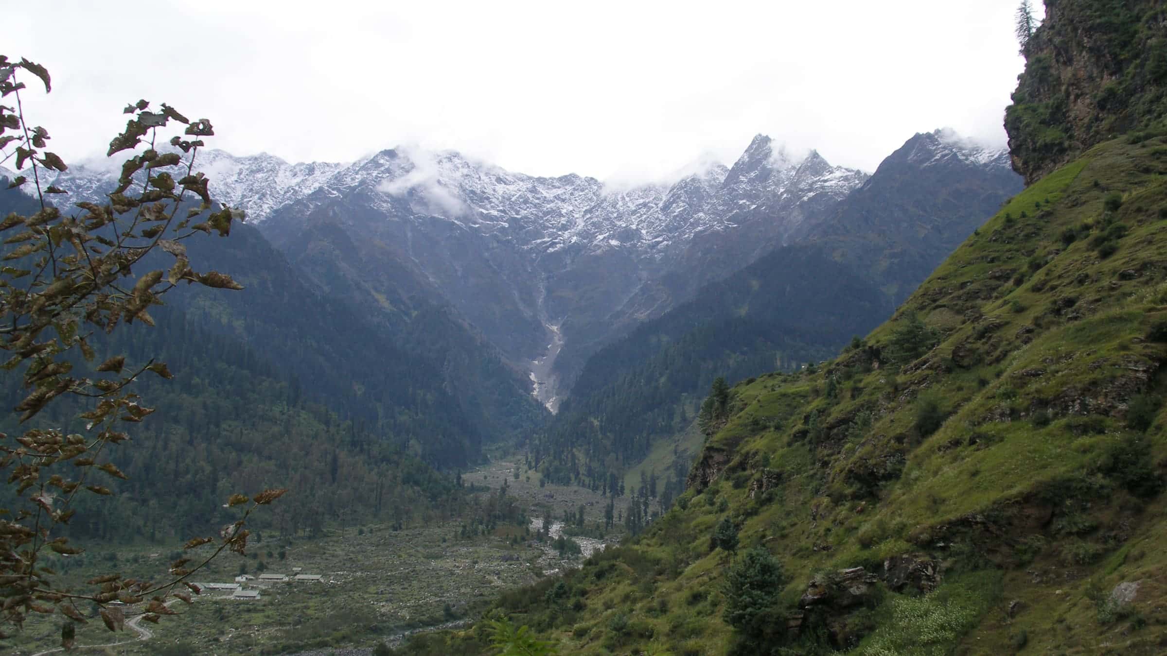Snow-capped Himalayan peaks above the green Kullu valley